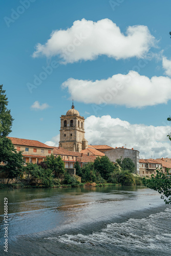 Tower of a gothic church near the river on a summer day. Aguilar de Campoo, Spain