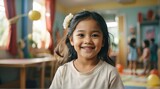 Portrait of a happy kid filipino girl playing on a kindergarten room from Generative AI