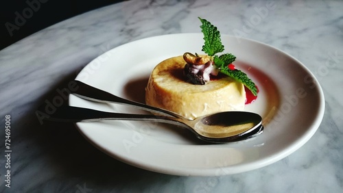 Delicious caramel pudding beautifully presented on a white plate resting on a table