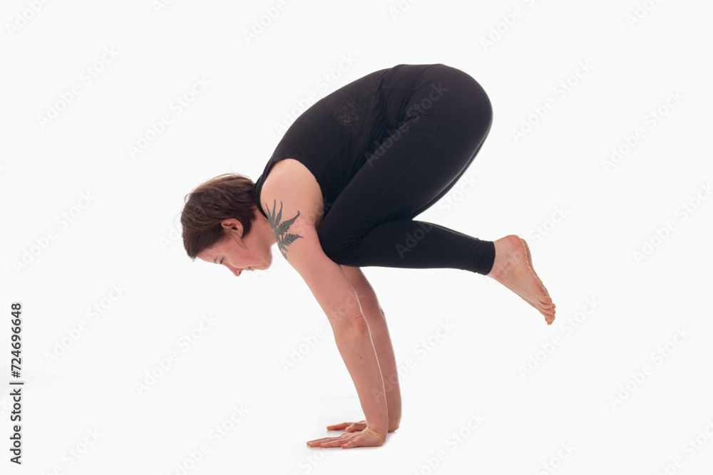 Bakasana, Ashtanga yoga Side view of woman wearing sportswear doing Yoga exercise against white background. Bakasana, Ashtanga yoga Side view of woman wearing sportswear doing Yoga exercise against white background.