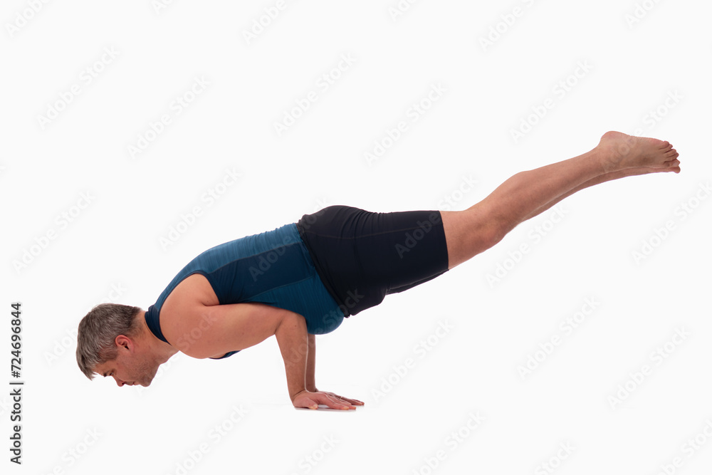 Mayurasana, Ashtanga yoga Side view of man wearing sportswear doing Yoga exercise against white background. Mayurasana, Ashtanga yoga Side view of man wearing sportswear doing Yoga exercise against white background.