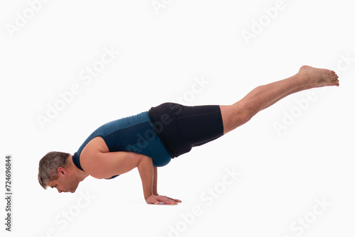 Mayurasana, Ashtanga yoga Side view of man wearing sportswear doing Yoga exercise against white background.