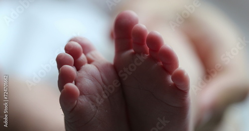 Newborn baby feet in macro close-up. Infant foot together in first week of life