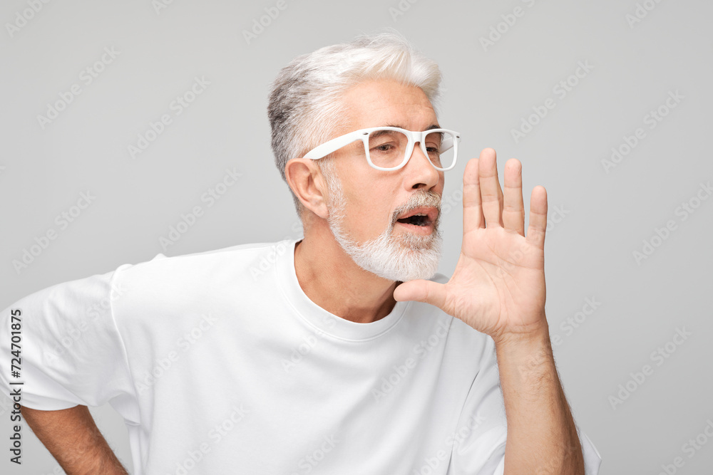 Portrait of senior man in white shouting loudly with hands, news, palms folded like megaphone isolated on white background Portrait of senior man in white shouting loudly with hands, news, palms folded like megaphone isolated on white background