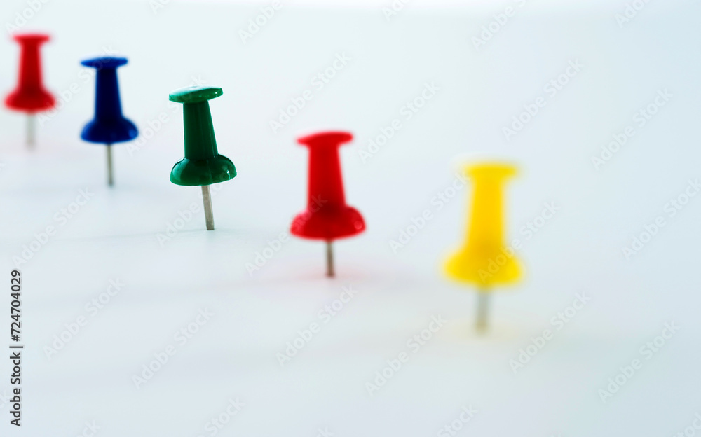 Push pins in a row isolated on white Push pins in a row isolated on white