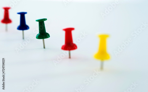 Push pins in a row isolated on white