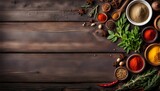 Food background on a dark brown wooden table. Herbs and spices on an old wooden table top view. Free space for text. Cooking ingredients, copy space.