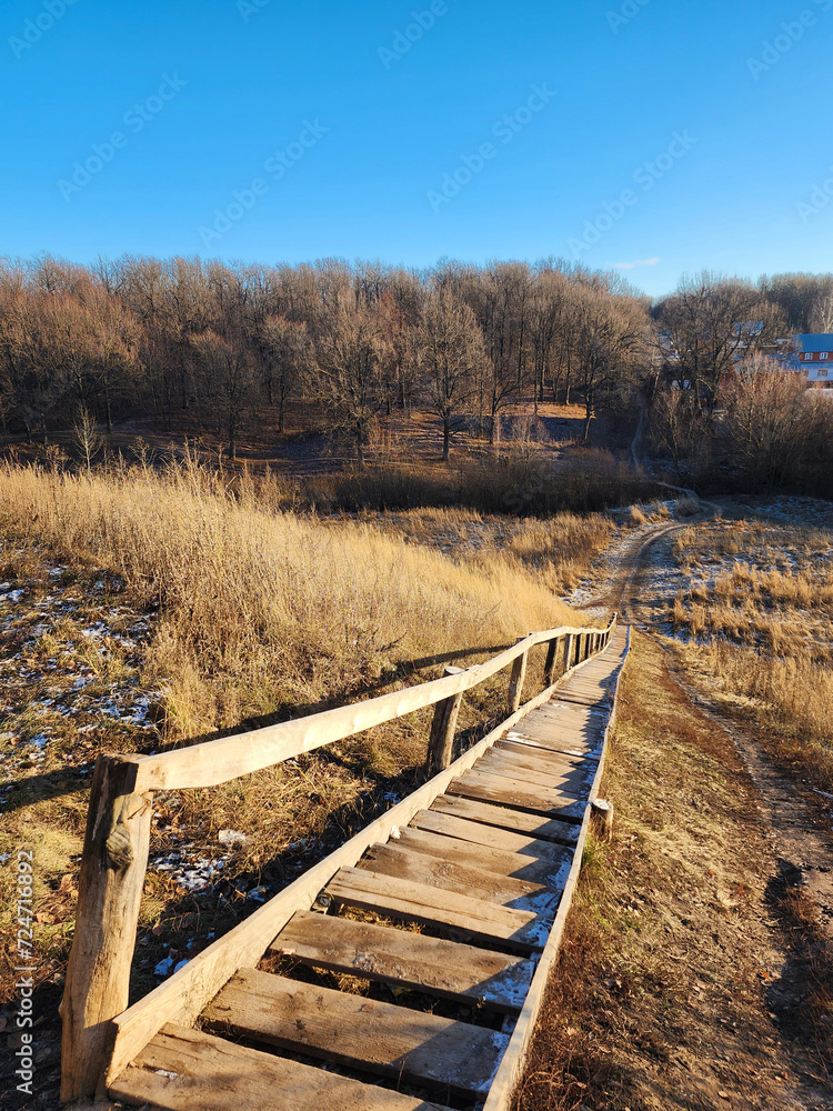 Long old wooden staircase in the village. Rural lifestyle. Long old wooden staircase in the village. Rural lifestyle.