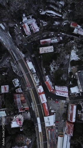 view of a train railway and the rural village coverd by snow
