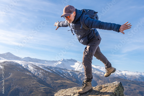 Adventurous Man Balancing on a Mountain Edge in Sierra Nevada