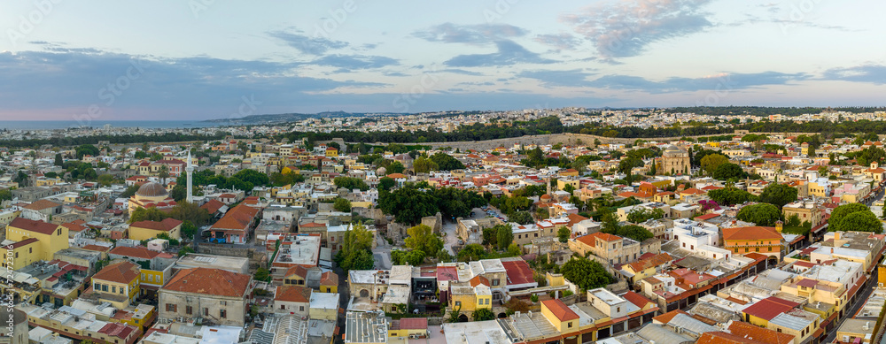 Naklejka premium Rhodes old town houses, Mosque of Suleiman and surrounding fortifications at sunrise, Greece, Aerial view 
