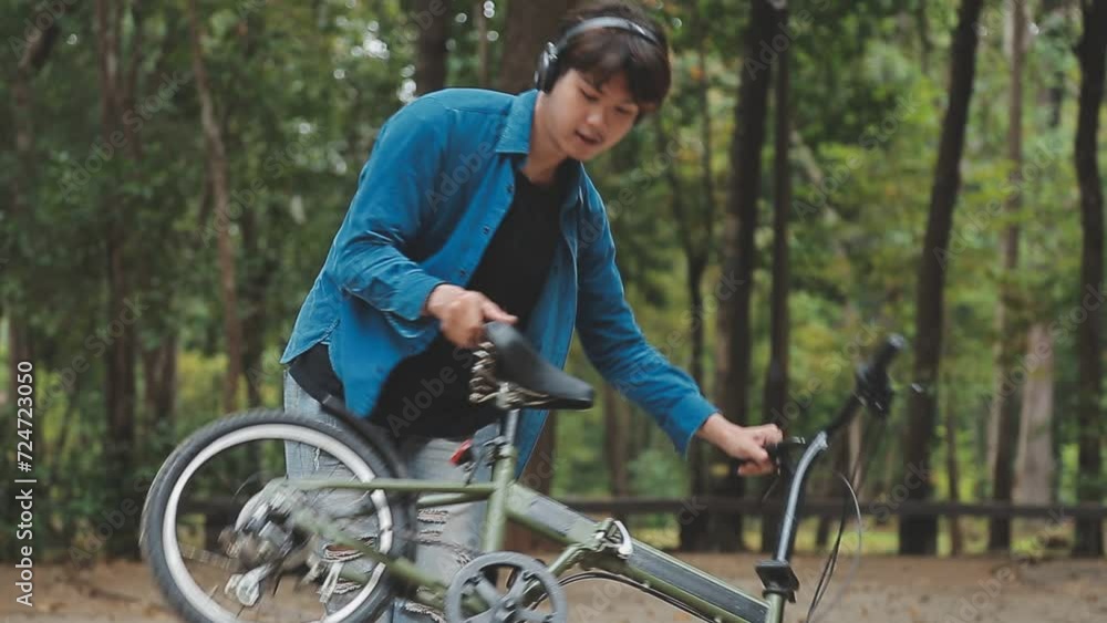 Healthy and active lifestyle, going to work on eco transport. Smiling attractive millennial male employee in glasses with bag and cup of takeaway coffee, moving bike in city park in summer, outdoor Healthy and active lifestyle, going to work on eco transport. Smiling attractive millennial male employee in glasses with bag and cup of takeaway coffee, moving bike in city park in summer, outdoor