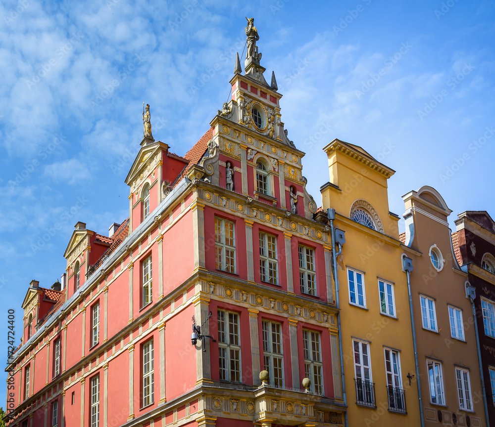 Facade of beautiful typical colorful houses on Dluga street (Dlugi Targ square) in old historical town centre on a sunny summer day, Gdansk, Poland