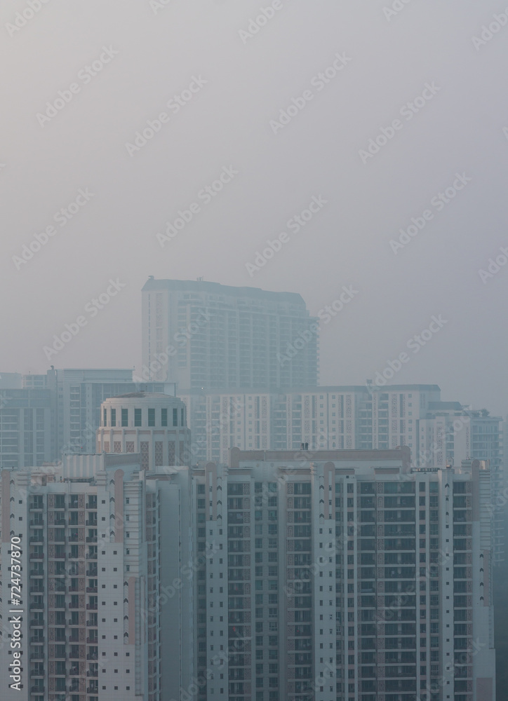Foggy winter evening in Gurgaon,Haryana,India. Luxury residential apartments and commercial buildings with urban,modern architecture. Gurugram,Delhi NCR cityscape with dense fog at Sunset,