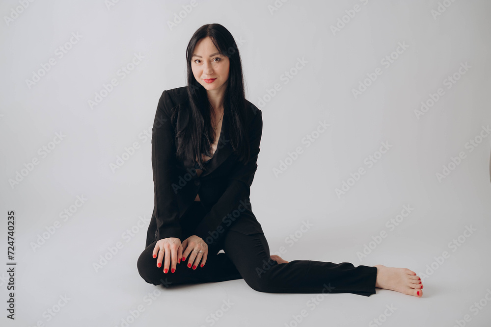 woman in black costume, office clothes, studio photo on white backdrop woman in black costume, office clothes, studio photo on white backdrop