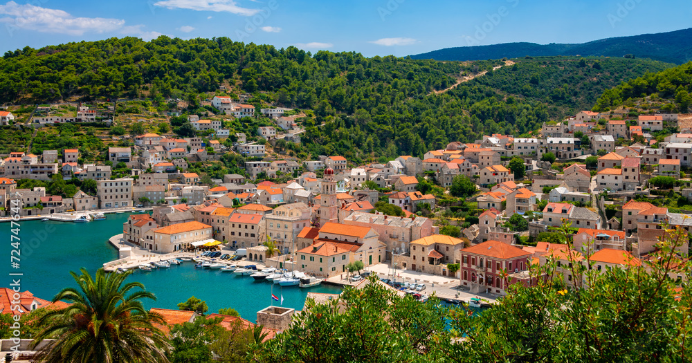 Pučišća village panorama on Brac island, Croatia. Mediterranean holiday destination with picturesque historic harbor fjord in summer with yachts, sailing boats. Idyllic atmosphere in adriatic sea.