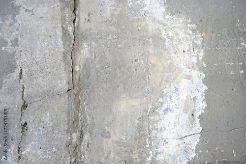 Real closeup photography texture of grey and chipped white painted concrete structure floor or wall useful as industrial urban background or overlay