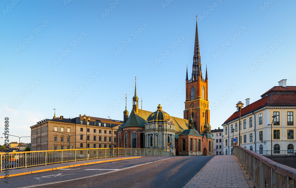 Obraz premium The Riddarholmen Church in Stockholm, Sweden. Cityscape of Stockholm, Sweden. Evening time and soft sunlight. A walk through the city. Panoramic view.