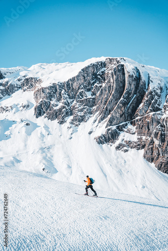 A man on ski alpine tour throught snowy Alps in Switzerland or Austria, Backcountry skier in Alps