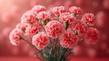  a bunch of pink carnations in a vase on a red surface with blurry boke of pink balls in the background and a red wall in the background.