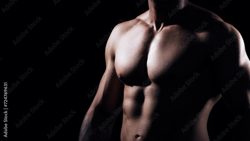 Fit and sporty bodybuilder over black background. Bodybuilder training using barbell. The concept of sport and fitness. Fit and sporty bodybuilder over black background. Bodybuilder training using barbell. The concept of sport and fitness.