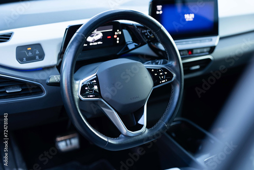 Interior of prestige modern car. Leather comfortable seats, dashboard and steering wheel. Cockpit with exclusive decoration. Modern electric car interior luxury photo