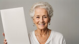 Happy old woman holding blank white banner sign, closeup isolated studio portrait