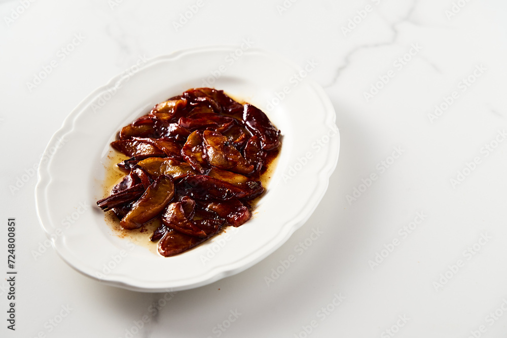 Caramelized apples with spices in white plate. Can be filling for pie or crumble and served over French toasts or pancakes. High key food photo Caramelized apples with spices in white plate. Can be filling for pie or crumble and served over French toasts or pancakes. High key food photo