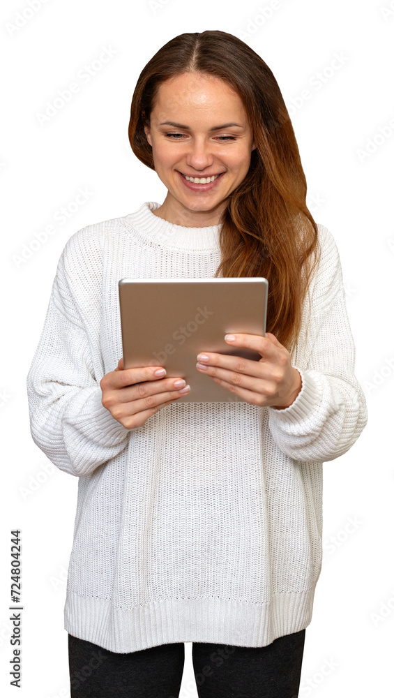 Isolated young brunette woman with long hair wearing a white sweater using a digital tablet and smiling.