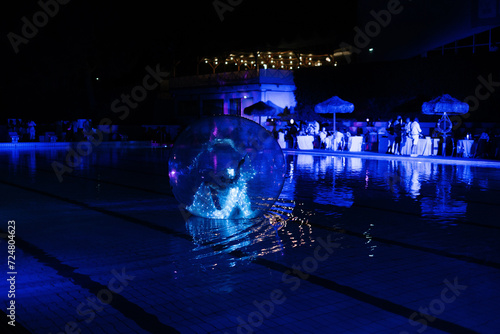 bright dancer in a water ball dancing in the pool