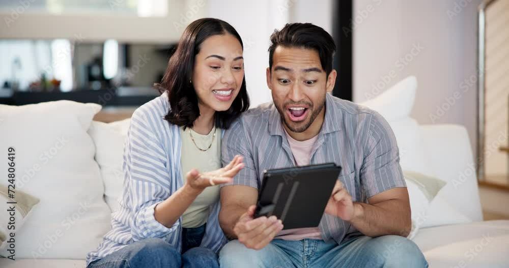 Happy couple, tablet and sofa for online games, funny post or social media in living room with internet search. Excited interracial man and woman typing and laughing with digital technology at home Happy couple, tablet and sofa for online games, funny post or social media in living room with internet search. Excited interracial man and woman typing and laughing with digital technology at home