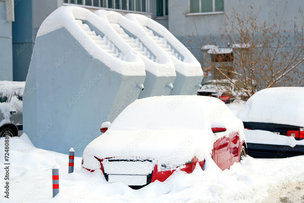 Snow covered car stuck at backyard. Car buried after winter snow storm. Car trapped in snow