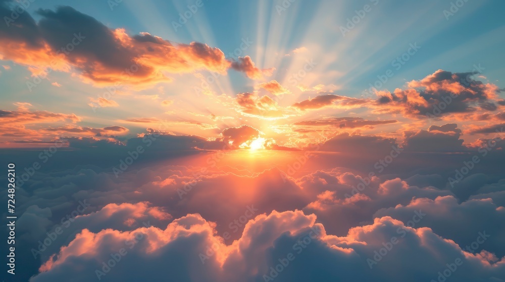 Sunrise dramatic blue sky with orange sun rays breaking through the clouds, stock photo