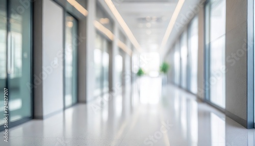 Abstract Blur of a Modern Glass Corridor. A defocused image captures the light-filled expanse of a modern corridor  its glass walls reflecting the bright ambience