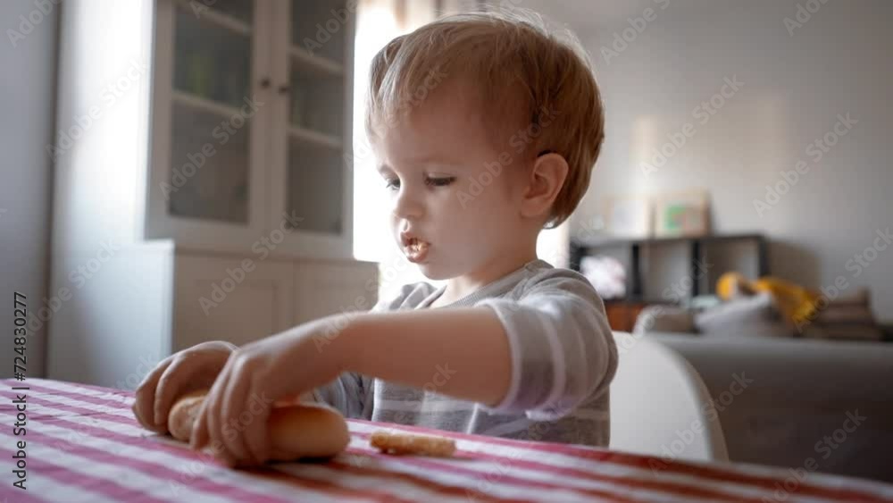 Watch as a curious and adventurous little boy embarks on a gastronomic exploration, sitting at a table and devouring delectable food with enthusiasm. Watch as a curious and adventurous little boy embarks on a gastronomic exploration, sitting at a table and devouring delectable food with enthusiasm.