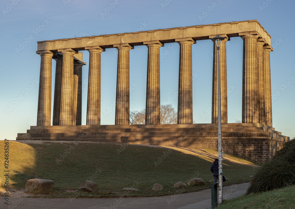 A view of the National Monument of Scotland with a bright blue sky in the background situated on Calton Hill at Edinburgh city. Scotland, Space for text, Selective focus.