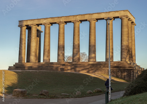 A view of the National Monument of Scotland with a bright blue sky in the background situated on Calton Hill at Edinburgh city. Scotland, Space for text, Selective focus.