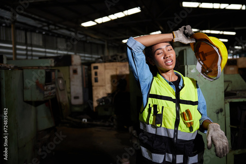 Fotografija worker or engineer feeling tired from hot weather over heat in the factory