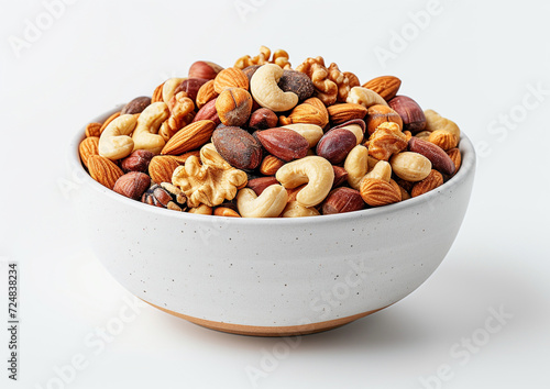 mixed nuts in a white ceramic bowl, the mix vibrant and colorful, set against a white background with a drop shadow for depth