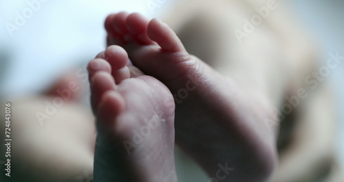Small newborn baby feet in first days of life