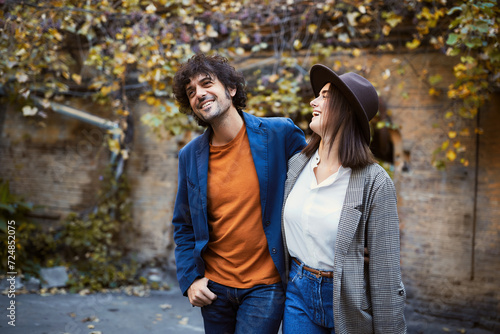 Charming couple embracing  taking a leisurely stroll and have funny talking