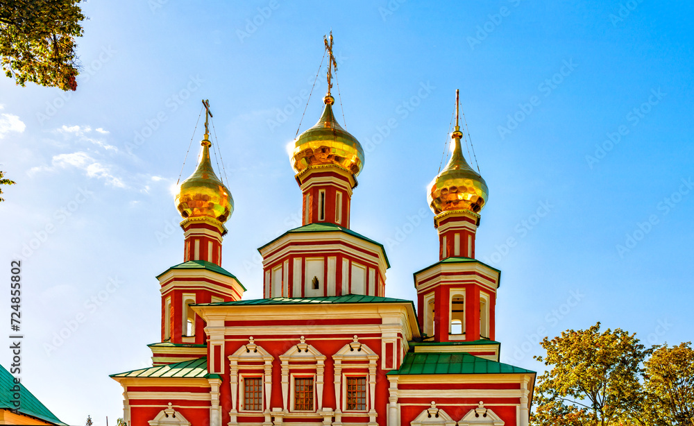 The upper part of the building of the Intercession Church with domes and crosses in the Novodevichy Convent in Moscow