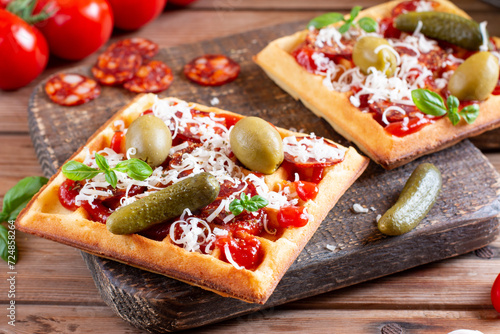 Pizza Waffles, the ingredients, sausage and herbs on a table. photo