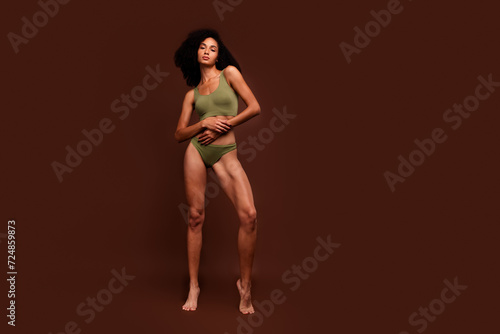 No filter full length photo of stunning girl posing khaki fashion collection underwear empty space isolated on brown color background © deagreez