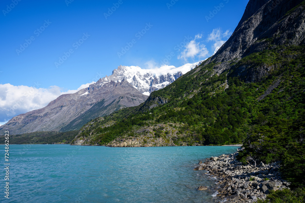 Obraz premium Light Blue Lagoon Shore, Snowcapped Mountain Background, Lago Nordenskjöld- Patagonia, Torres del Paine National Park 