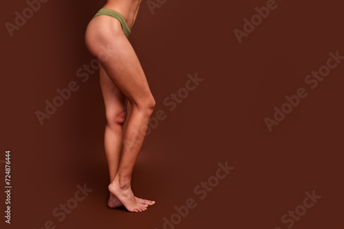 Studio no retouch profile cropped photo of adorable slim lady legs walking empty space isolated brown color background