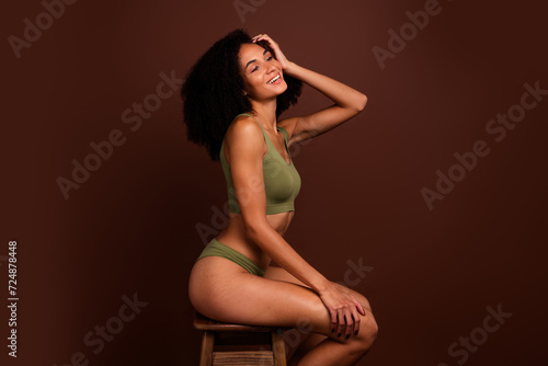 Profile side no retouch photo of adorable lovely cheerful girl feeling confident and comfortable isolated on brown color background