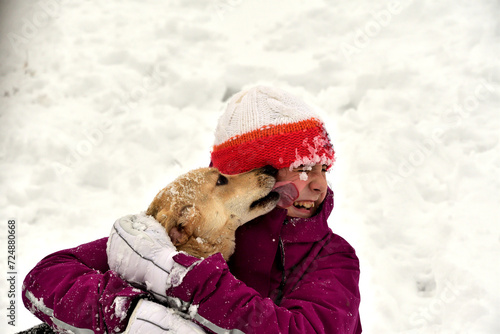 Domestic dog to snuggle with girl on the snow