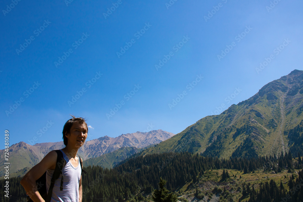A man who hikes mountain, success, achievement in mountains. Kazakhstan
