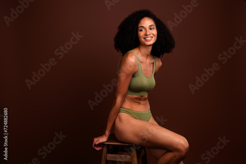 No filter photo of cheerful charming woman loving her body perfect shape feeling confident khaki lingerie isolated brown color background © deagreez